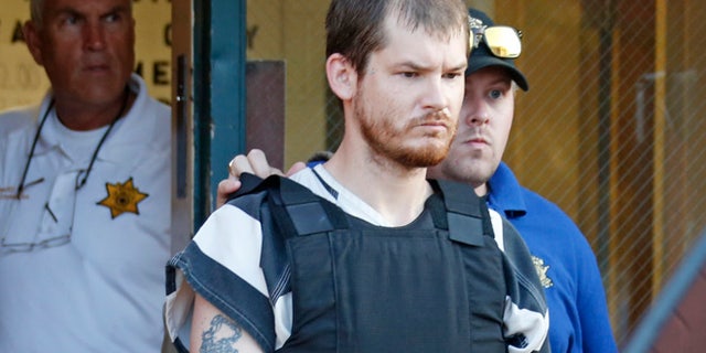 Sept. 11: Smith County Sheriff Charlie Crumpton, left, watches as Timothy Ray Jones Jr., is escorted by lawmen out of the Smith County Jail to a vehicle for transport to Lexington County, S.C.