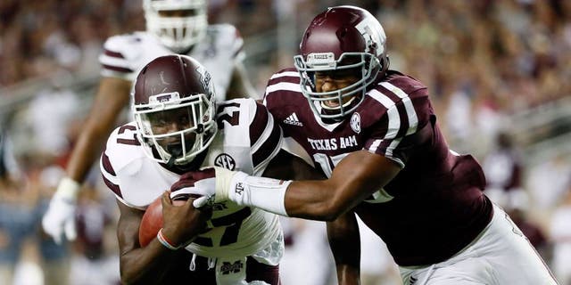 Oct 3, 2015; College Station, TX, USA; Mississippi State Bulldogs running back Aeris Williams (27) carries the ball as Texas A&amp;M Aggies defensive lineman Myles Garrett (right) defends during the second half at Kyle Field. Texas A&amp;M won 30-17. Mandatory Credit: Soobum Im-USA TODAY Sports
