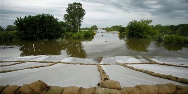June 16: Floodwaters from the Missouri River covering Highway 333 outside of town approach a levee in Hamburg, Iowa.