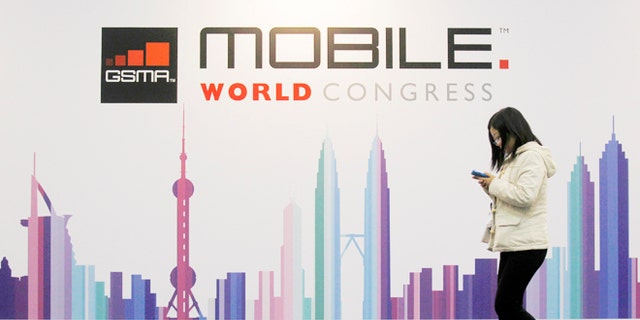Feb. 28, 2013: A visitor walks past a Mobile World Congress banner in Barcelona.