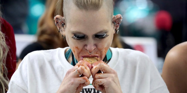 Competitive eater Molly Schuyler gnawed her way through a record 501 chicken wings in 30 minutes to win her third Wing Bowl in Philadelphia.
