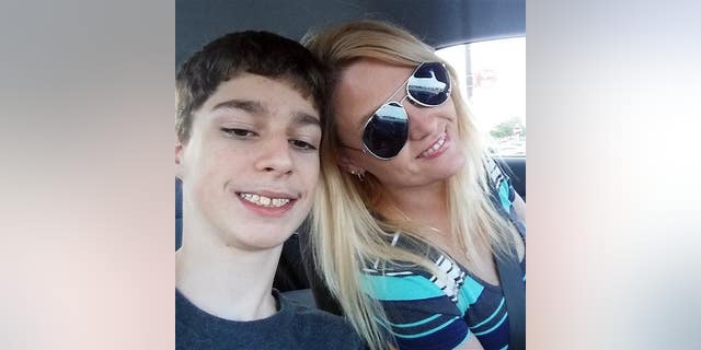 Alex Hoover poses for a photo with his mother, Rene. Alex has a terminal heart condition and has not returned to school because of what his mother says is a dispute over how he might die.