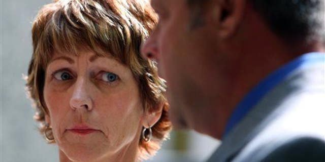 In this June 25, 2015, photo, Bonnie Liltz looks toward her attorney as he speaks to the media in Rolling Meadows, Ill.