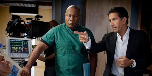 This undated image released by TNT shows Ving Rhames portraying Dr. Jorge Villanueva, left, and Executive Producer Dr. Sanjay Gupta on the set of "Monday Mornings" a medical drama premiering Monday, Feb. 4, 2013 at 10 p.m. EST on TNT.