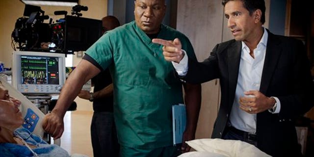 This undated image released by TNT shows Ving Rhames portraying Dr. Jorge Villanueva, left, and Executive Producer Dr. Sanjay Gupta on the set of "Monday Mornings" a medical drama premiering Monday, Feb. 4, 2013 at 10 p.m. EST on TNT.