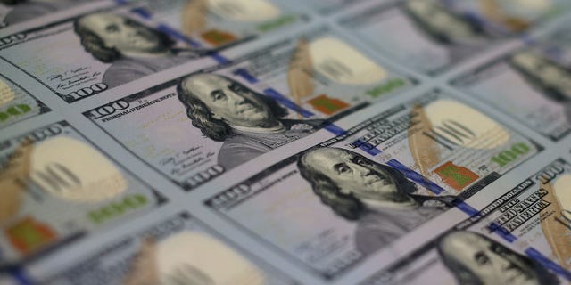 WASHINGTON, DC - MAY 20: Newly redesigned $100 notes lay in stacks at the Bureau of Engraving and Printing on May 20, 2013 in Washington, DC. The one hundred dollar bills will be released this fall and has new security features, such as a duplicating portrait of Benjamin Franklin and microprinting added to make the bill more difficult to counterfeit. (Photo by Mark Wilson/Getty Images)