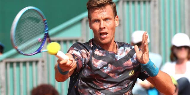 Thomas Berdych of Czech Republic plays a return to Ukrainian Sergiy Stakhovsky during their match of the Monte Carlo Tennis Masters tournament in Monaco, Wednesday, April 15, 2015. (AP Photo/Lionel Cironneau)