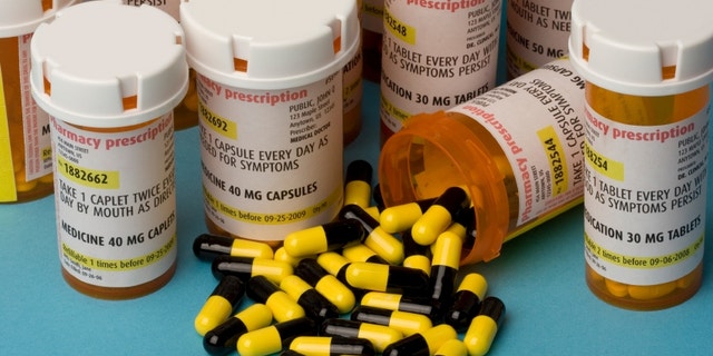 Bottles of prescription medication. Labels are fake, with false information.