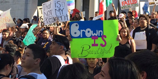 High school students protest against the election of President-elect Donald Trump on the steps of Los Angeles City Hall Monday, Nov. 14, 2016. Students from several Los Angeles schools have walked out of classes to protest the election of Donald Trump as president. (AP Photo/Reed Saxon)