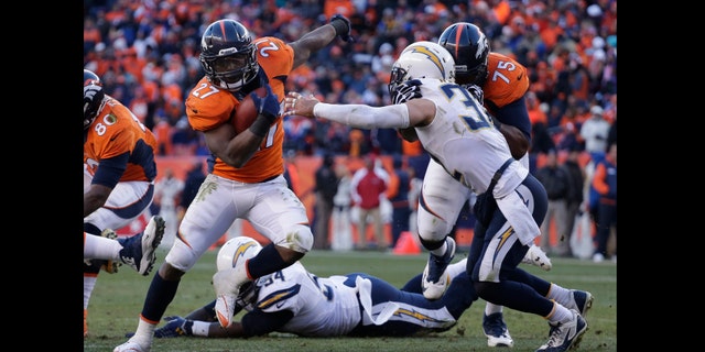 Denver Broncos running back Knowshon Moreno (27) sidesteps San Diego Chargers free safety Eric Weddle (32) in the second quarter of an NFL AFC division playoff football game, Sunday, Jan. 12, 2014, in Denver. (AP Photo/Charlie Riedel)