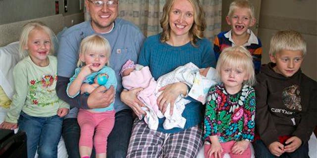 Tiffany and Chris Goodwin of Three Forks, Mont., pose with their children, including 3 sets of twins.