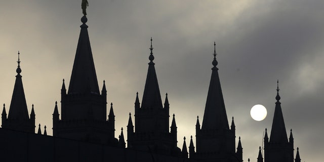 FILE: The angel Moroni statue, silhouetted against a cloud-covered sky, sits atop the Salt Lake Temple in Temple Square in Salt Lake City.