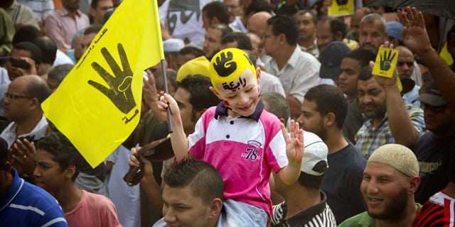 September 27, 2013: A young Egyptian boy participates in a demonstration by supporters of ousted President Mohammed Morsi in the Maadi district of Cairo, Egypt. (AP Photo/Hamada Elrasam, File)