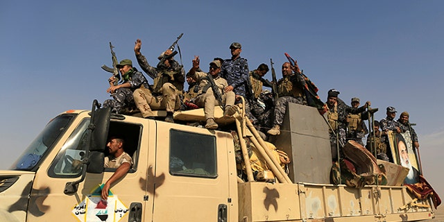 Newly trained police formed from people displaced by Islamic State militants sit on a truck bound for the frontline of the Mosul offensive against Islamic State, near Bazgirtan, Iraq, October 26, 2016. REUTERS/Zohra Bensemra - RTX2QIET