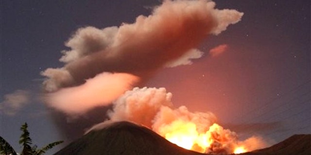 July 14, 2011: The glow of lava from Mount Lokon's eruption is seen against the night sky in July, 2011. The volcano erupted yet again early Tuesday, Dec. 27, 2011.