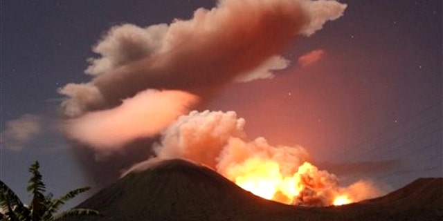 July 14, 2011: The glow of lava from Mount Lokon's eruption is seen against the night sky in July, 2011. The volcano erupted yet again early Tuesday, Dec. 27, 2011.