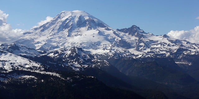 FILE -- In this file photo taken June 19, 2013, Mount Rainier is seen from a helicopter flying south of the mountain and west of Yakima, Wash. (AP Photo/Elaine Thompson, File)