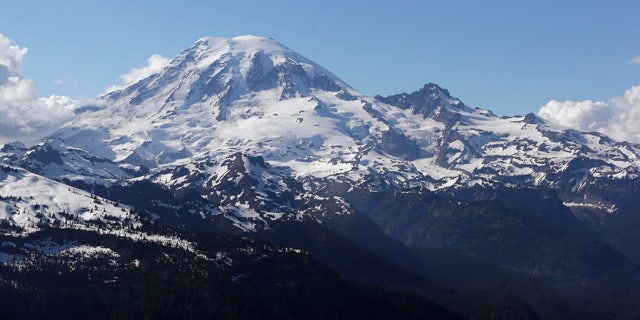 FILE -- In this file photo taken June 19, 2013, Mount Rainier is seen from a helicopter flying south of the mountain and west of Yakima, Wash. (AP Photo/Elaine Thompson, File)