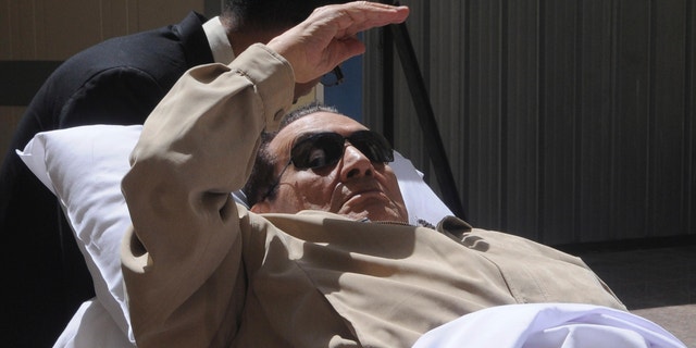 June 2, 2012: Egypt's ex-President Hosni Mubarak lays on a gurney as he arrives at the police academy courthouse in Cairo, Egypt.