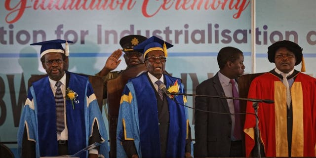 Zimbabwe's President Robert Mugabe stands for the national anthem during his first public appearance since the military took control of the country, Nov. 17, 2017.