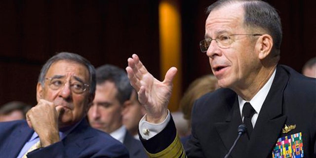Defense Secretary Leon Panetta looks on at left as Joint Chiefs Chairman Adm. Michael Mullen, testifies on Capitol Hill in Washington, Thursday, Sept. 22, 2011, before the Senate Armed Services Committee hearing on U.S. strategy in Afghanistan and Iraq.