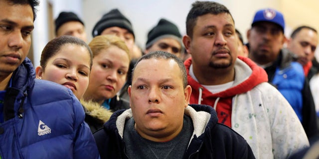 People wait in line to apply for municipal identification cards in the Bronx borough of New York on Jan. 12, 2015.