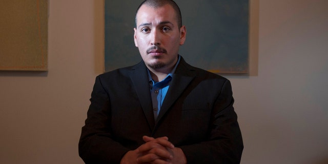 In this Dec. 7, 2013 photo, Eder Herrera poses for a photo. The Southern California city of Brea will pay $700,000 to Herrera who was arrested in the 2011 killings of his mother and brother but was freed when his high school friend confessed to the crimes, lawyers said Tuesday, April 28, 2015. (Miguel Vasconcellos/The Orange County Register via AP)