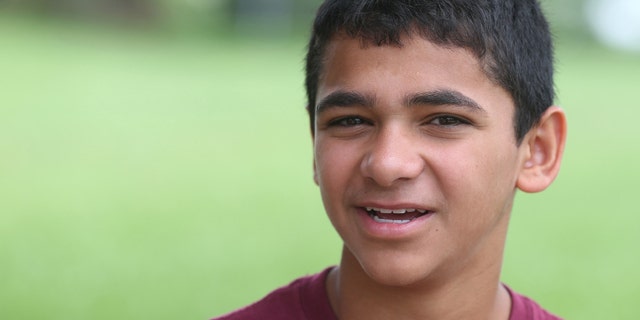 In this June 23, 2015 photo, John Handley High School sophomore Joseph Rosenfeld poses for a photo at the school in Winchester, Va.