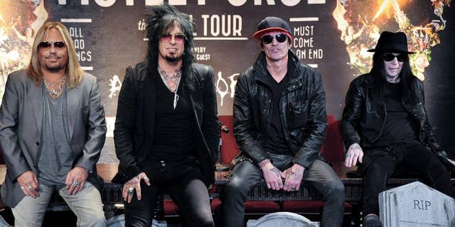 FILE - This Jan. 28, 2014 file photo shows, from left, Vince Neil, Nikki Sixx, Tommy Lee, and Mick Mars of Motley Crue at a press conference in Los Angeles. Country artists including Rascal Flatts, Florida Georgia Line and Brantley Gilbert perform on the 15-song album "Nashville Outlaws: A Tribute to Motley Crue," released Tuesday, Aug. 19. (Photo by Richard Shotwell/Invision/AP, File)