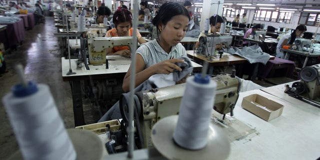 April 21: Young workers use sewing machines at a garment factory in Yangon, Myanmar.