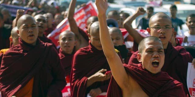 Myanmar Buddhist monks shout slogans as they march to protest against a resolution adopted by the UN General Assembly calling on Myanmar to grant citizenship to Rohingya, Friday, Jan.16, 2015, in Yangon, Myanmar. The United Nations General Assembly’s human rights committee passed a resolution last year, urging Myanmar to grant citizenship to the Rohingya, a stateless Muslim minority group. (AP Photo/Khin Maung Win)