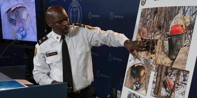 In a Tuesday, Feb. 24, 2015 photo, Toronto's Deputy Police Chief Mark Saunders explains evidence photos as he speaks to the media about a tunnel found near one of the venues for this year's Pan American Games, at a press conference in Toronto. Police said Monday March 2, 2015 that two young men who built the mysterious tunnel had no criminal intent, they just wanted a man cave. Const. Victor Kwong said tips from the public helped them identify the two men in their 20s responsible for building the underground chamber near a Pan Am Games venue. (AP Photo/The Canadian Press, Chris Young)
