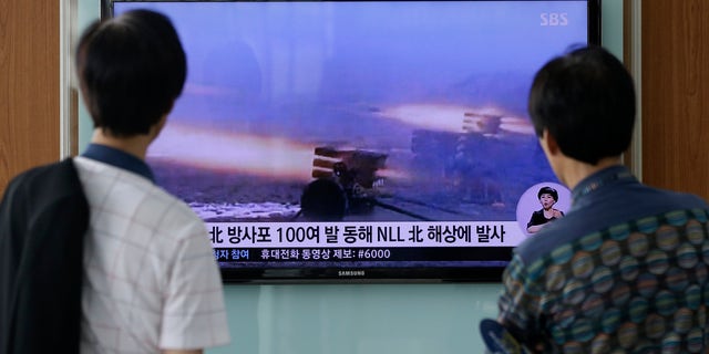 July 14, 2014 - People at Seoul Railway Station in Seoul, South Korea, watch a TV news report on North Korea firing artillery shells into waters near its sea border with South Korea, Seoul's military said, a day after the country test-launched two ballistic missiles in the latest of a series of weapon tests.