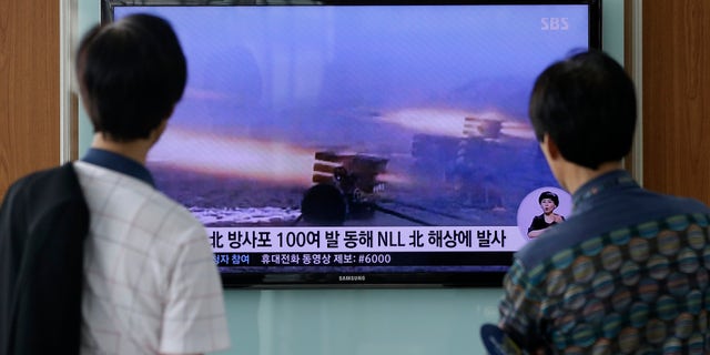 July 14, 2014 - People at Seoul Railway Station in Seoul, South Korea, watch a TV news report on North Korea firing artillery shells into waters near its sea border with South Korea, Seoul's military said, a day after the country test-launched two ballistic missiles in the latest of a series of weapon tests.