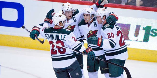 Thursday, Oct. 15: Minnesota Wild left wing Zach Parise (second from right) celebrates with right wing Jason Pominville (left), defenseman Ryan Suter (right) and center Mikko Koivu after scoring a power play goal in the first period against the Arizona Coyotes at Gila River Arena.