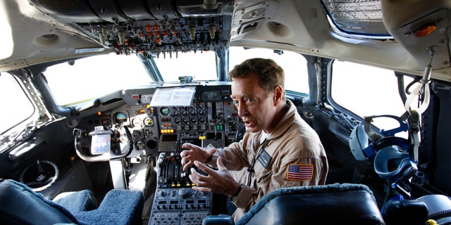 Flight engineer Bill Fleming sits in a plane cockpit as a team of NASA scientists prepare for a flight into Hurricane Earl to gather data about what makes some tropical storms intensify while others fizzle. The flight is part of a six-week NASA research mission to collect information that could help forecasters accurately predict how strong a hurricane will be.