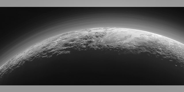 Just 15 minutes after its closest approach to Pluto on July 14, 2015, NASA’s New Horizons spacecraft looked back toward the sun and captured this near-sunset view of the rugged, icy mountains and flat ice plains extending to Pluto’s horizon.
