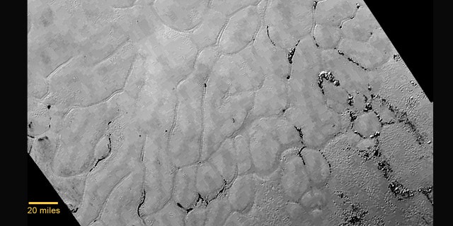 In the center left of Pluto’s vast heart-shaped feature lies a vast, craterless plain that appears to be no more than 100 million years old.