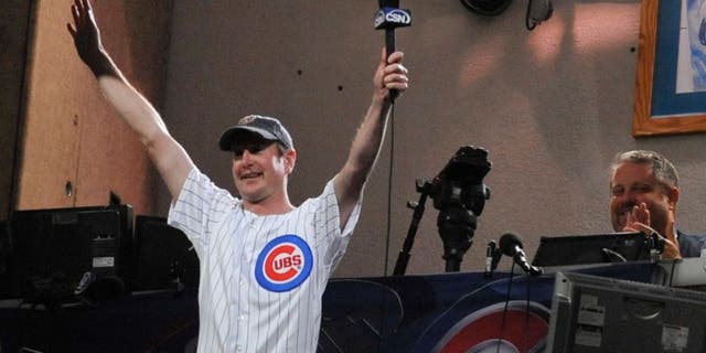 CHICAGO, IL - SEPTEMBER 19: NASCAR driver Kurt Busch sings take me out to the ball game during the Milwaukee Brewers Chicago Cubs game on September 19, 2011 at Wrigley Field in Chicago, Illinois. (Photo by David Banks/Getty Images)
