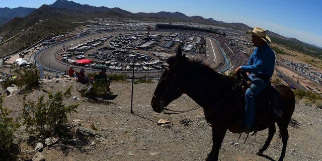 A race fan on horseback looks on during the NASCAR Sprint Cup Series CampingWorld.com 500 at Phoenix International Raceway on March 15, 2015 in Avondale, Arizona.