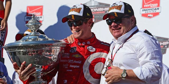 SONOMA, CA - AUGUST 30: Scott Dixon of New Zealand driver of the #9 Target Chip Ganassi Racing Chevrolet Dallara and team owner Chip Ganassi pose with the Championship Trophy presentation stage after winning the Verizon IndyCar Series GoPro Grand Prix of Sonoma at Sonoma Raceway on August 30, 2015 in Sonoma, California. (Photo by Robert Laberge/Getty Images)
