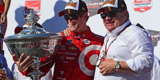 SONOMA, CA - AUGUST 30: Scott Dixon of New Zealand driver of the #9 Target Chip Ganassi Racing Chevrolet Dallara and team owner Chip Ganassi pose with the Championship Trophy presentation stage after winning the Verizon IndyCar Series GoPro Grand Prix of Sonoma at Sonoma Raceway on August 30, 2015 in Sonoma, California. (Photo by Robert Laberge/Getty Images)