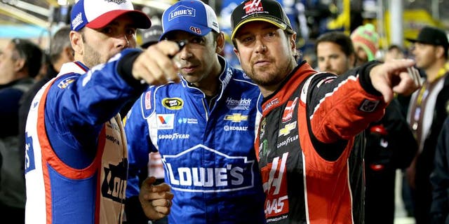 AVONDALE, AZ - NOVEMBER 15: (L-R) Jimmie Johnson, driver of the #48 Lowe's Patriotic Chevrolet, crew chief Chad Knaus and Kurt Busch, driver of the #41 Haas Automation Chevrolet, talk on pit road before the NASCAR Sprint Cup Series Quicken Loans Race for Heroes 500 at Phoenix International Raceway on November 15, 2015 in Avondale, Arizona. (Photo by Sean Gardner/Getty Images)