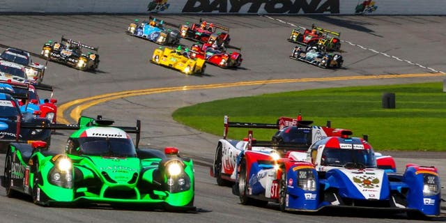 DAYTONA BEACH, FL - JANUARY 30: Prototype cars race into turn one at the start of the Rolex 24 at Daytona at Daytona International Speedway on January 30, 2016 in Daytona Beach, Florida. (Photo by Brian Cleary/Getty Images)