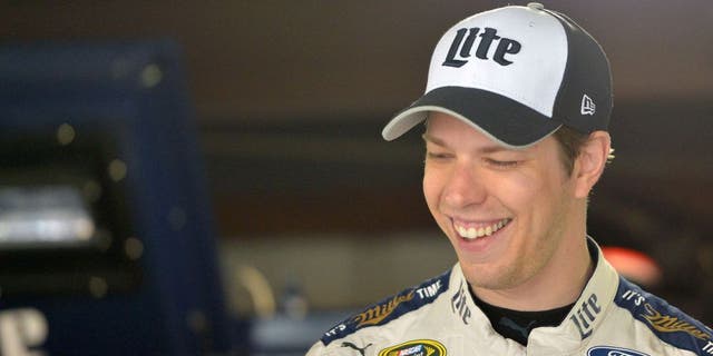 MARTINSVILLE, VA - APRIL 02: Brad Keselowski, driver of the #2 Miller Lite Ford, stands in the garage area during practice for the NASCAR Sprint Cup Series STP 500 at Martinsville Speedway on April 2, 2016 in Martinsville, Virginia. (Photo by Drew Hallowell/Getty Images)