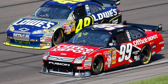 KANSAS CITY, KS - SEPTEMBER 28: Carl Edwards, driver of the #99 Office Depot Ford, and Jimmie Johnson, driver of the #48 Lowe's Chevrolet, drive during the NASCAR Sprint Cup Series Camping World RV 400 at Kansas Speedway on September 28, 2008 in Kansas City, Kansas. (Photo by John Harrelson/Getty Images for NASCAR)