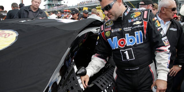 Sprint Cup Series driver Tony Stewart prepares for the Brickyard 400 auto race at the Indianapolis Motor Speedway in Indianapolis, Sunday, July 28, 2013. (AP Photo/Darron Cummings)