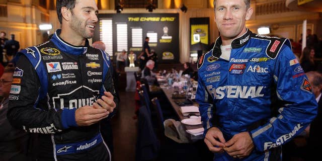 Jimmie Johnson, left, and Carl Edwards chat during the NASCAR Sprint Cup media day in Chicago, Thursday, Sept. 11, 2014. The 16 drivers in the Chase for the Sprint Cup championship took part in the event. The opening race in the Chase is at Chicagoland Speedway on Sunday in Joliet, Ill. (AP Photo/Nam Y. Huh)