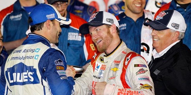 Dale Earnhardt Jr., center, celebrates in Victory Lane with teammate Jimmie Johnson, left, and team owner Rick Hendrick, right, after winning the NASCAR Daytona 500 Sprint Cup series auto race at Daytona International Speedway in Daytona Beach, Fla., Sunday, Feb. 23, 2014. (AP Photo/Terry Renna)