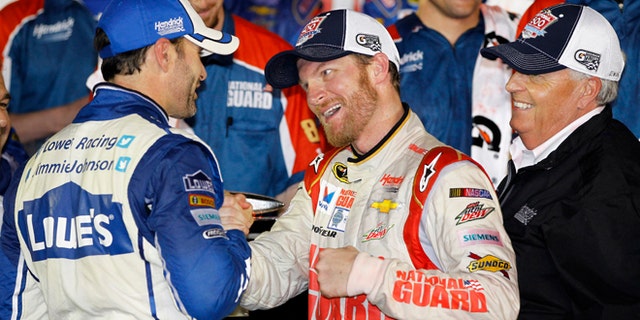 Dale Earnhardt Jr., center, celebrates in Victory Lane with teammate Jimmie Johnson, left, and team owner Rick Hendrick, right, after winning the NASCAR Daytona 500 Sprint Cup series auto race at Daytona International Speedway in Daytona Beach, Fla., Sunday, Feb. 23, 2014. (AP Photo/Terry Renna)